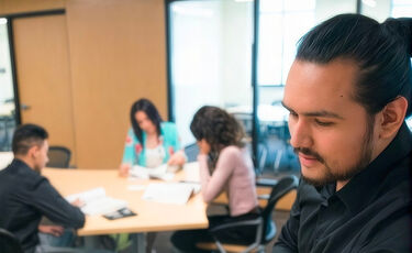 young man looking at admissions materials