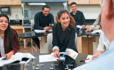 students talking to professor in lab